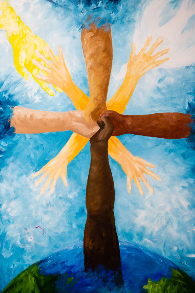 Painting on canvas of hands/arms of different skin tones reaching up from earth and clasped in the middle, along with a hand from the heavens and a white dove